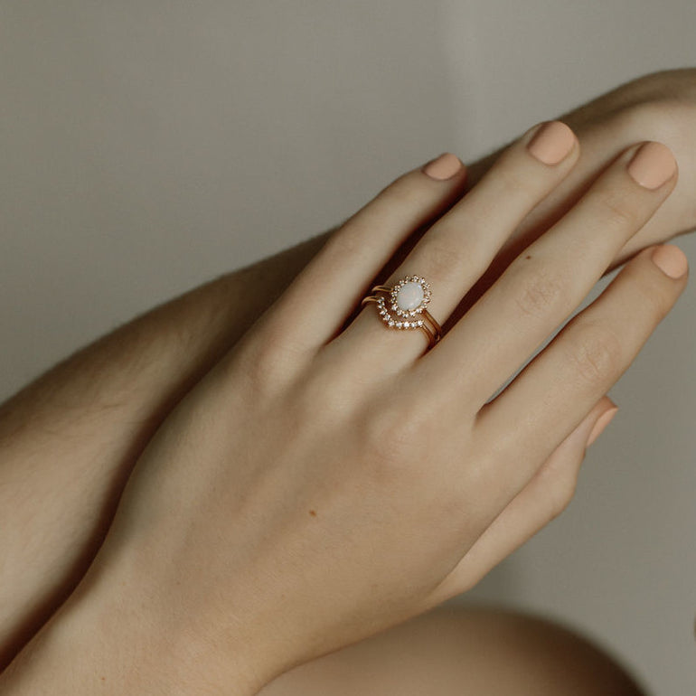 contour diamond wedding band with engagement ring on hand