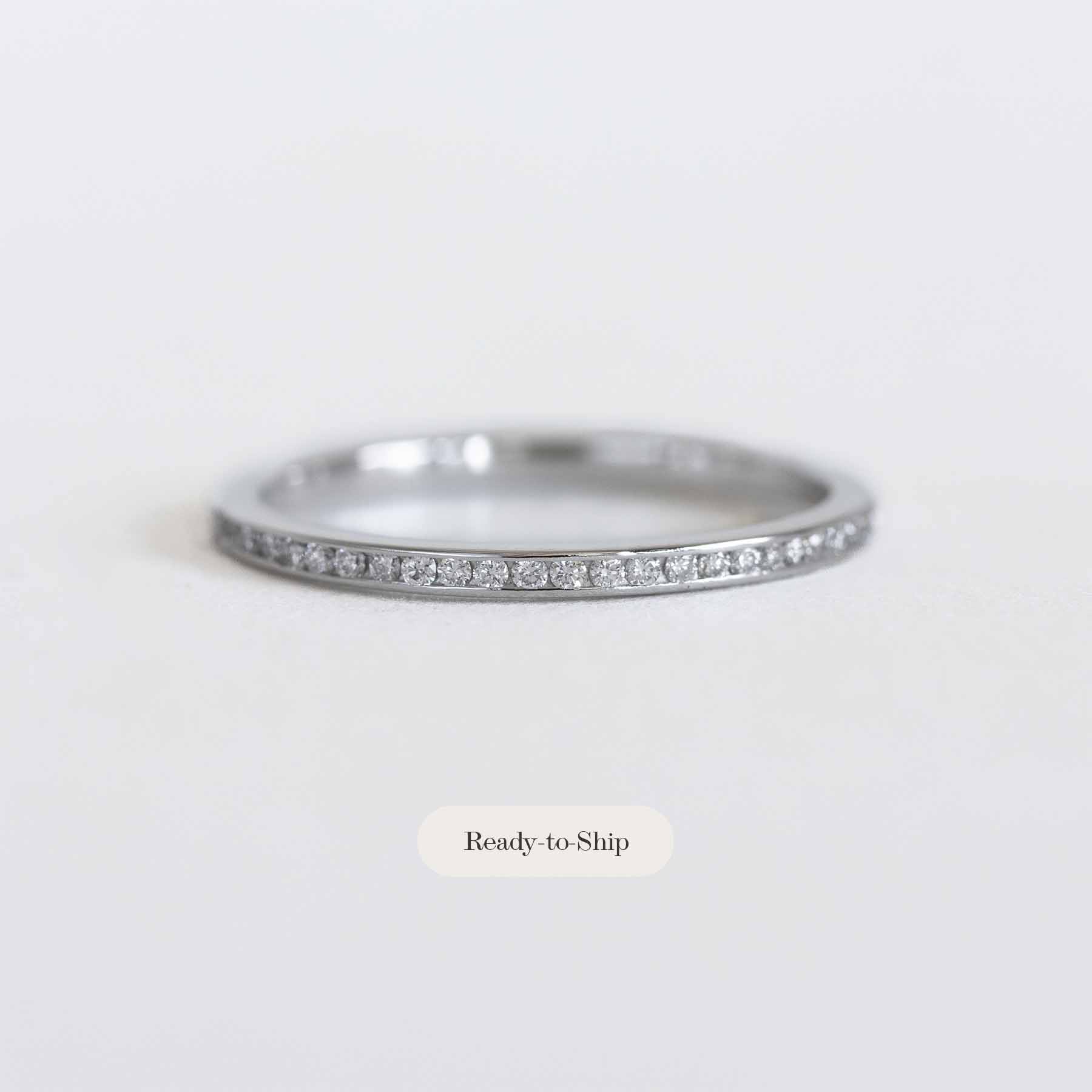 White gold ring with diamonds on a light gray background
