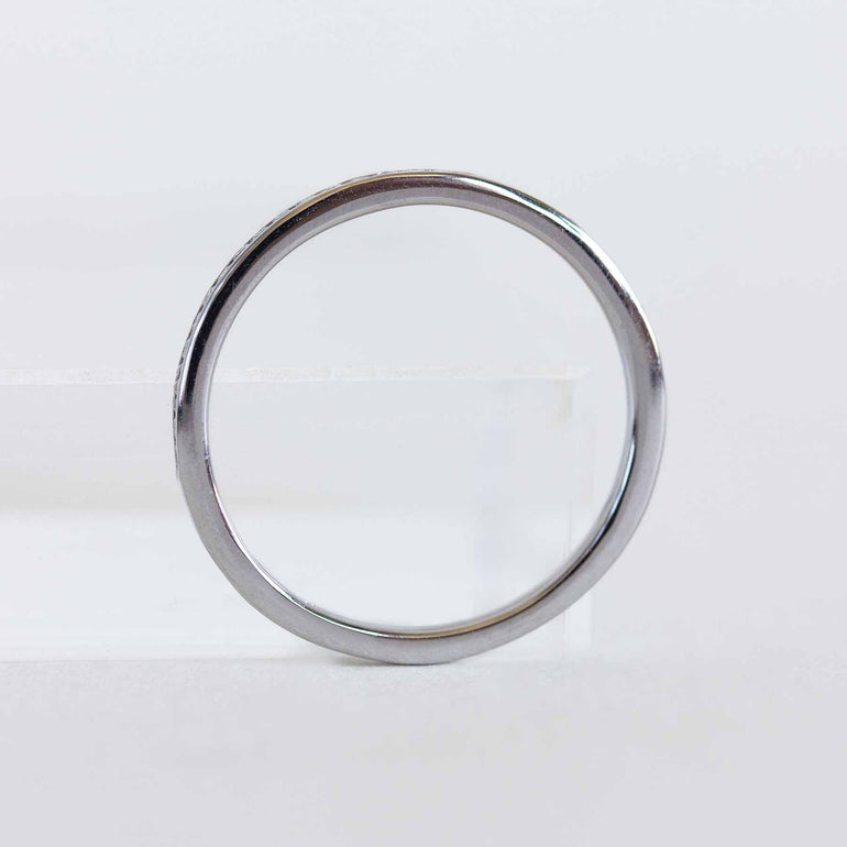 White gold ring with diamonds on a light gray background