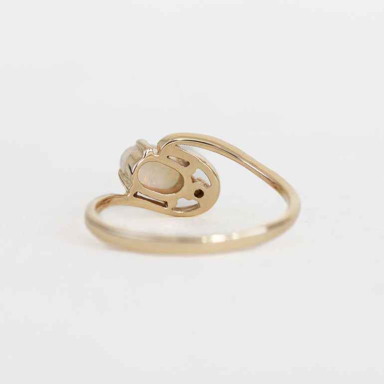 Gold ring with a heart design on a light gray background