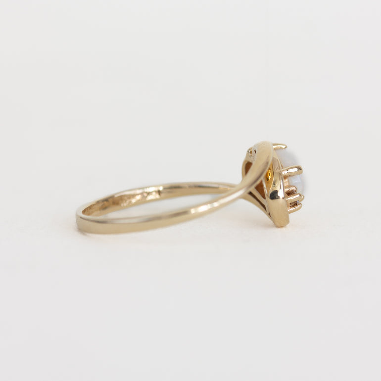 Rose gold ring with a diamond on a white background