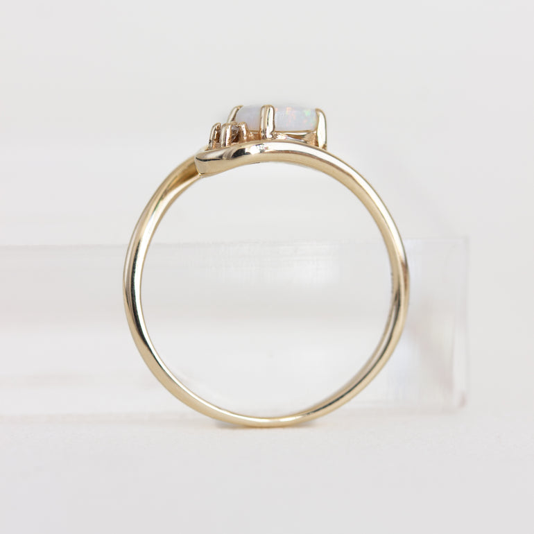 Gold ring with a diamond on a white background