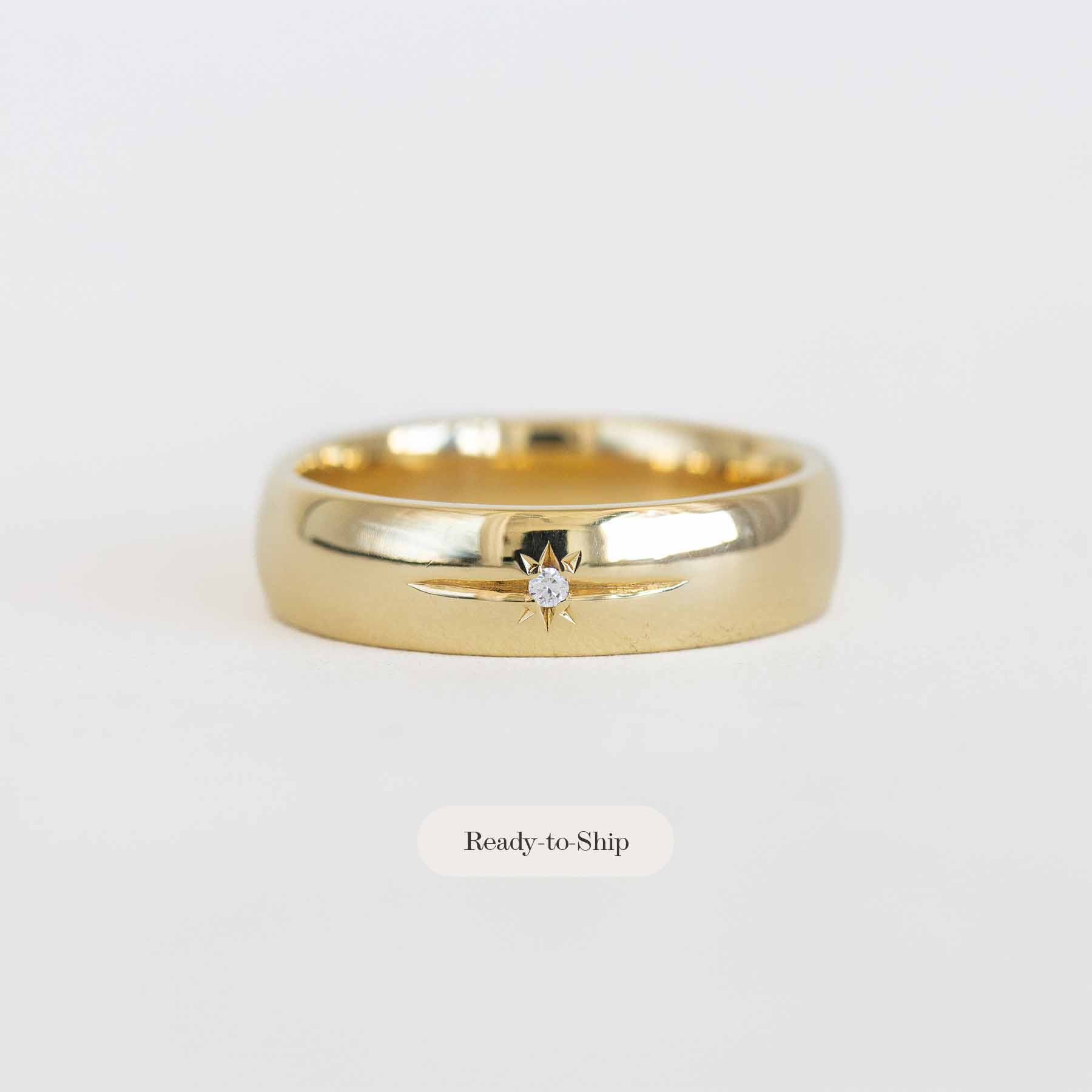 Gold ring with a diamond on a white background
