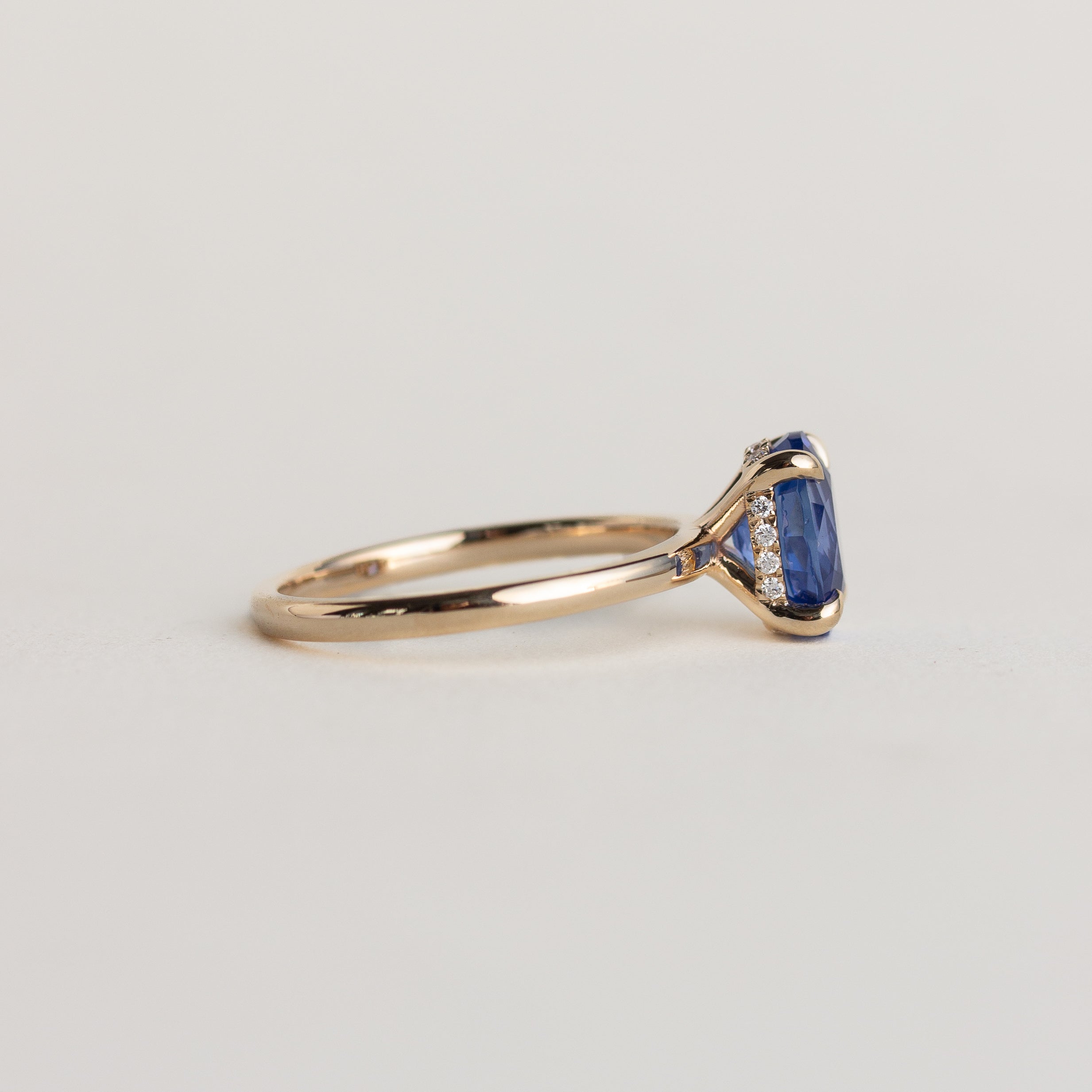 14K gold ring with brilliant blue solitaire oval sapphire and hidden diamond halo