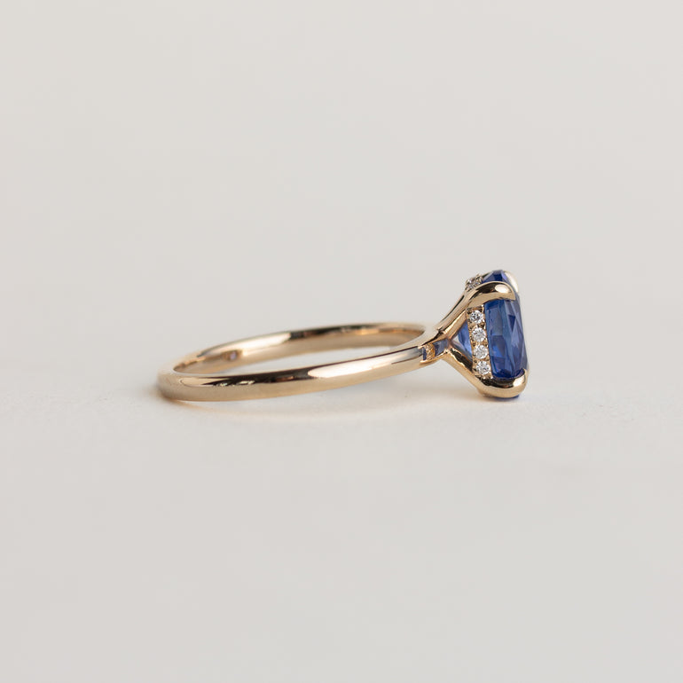 14K gold ring with brilliant blue solitaire oval sapphire and hidden diamond halo