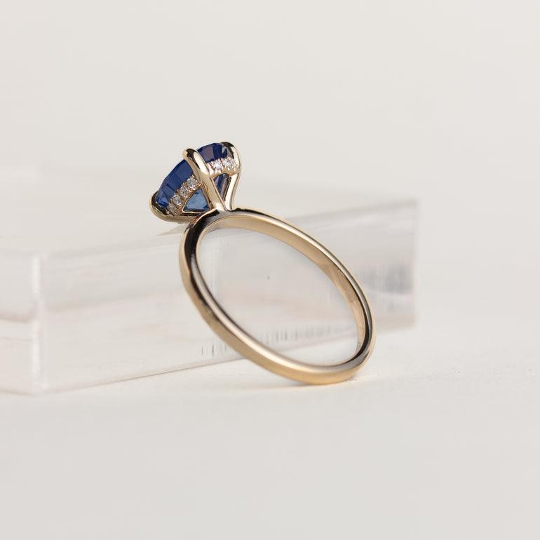 14K gold ring with brilliant blue solitaire oval sapphire and hidden diamond halo