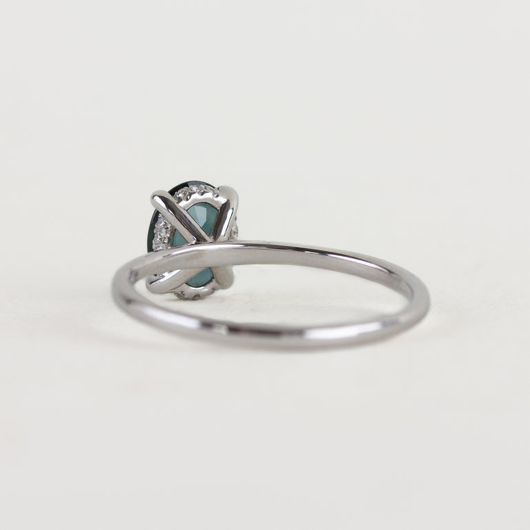 14K white gold ring with a moody dark teal sapphire