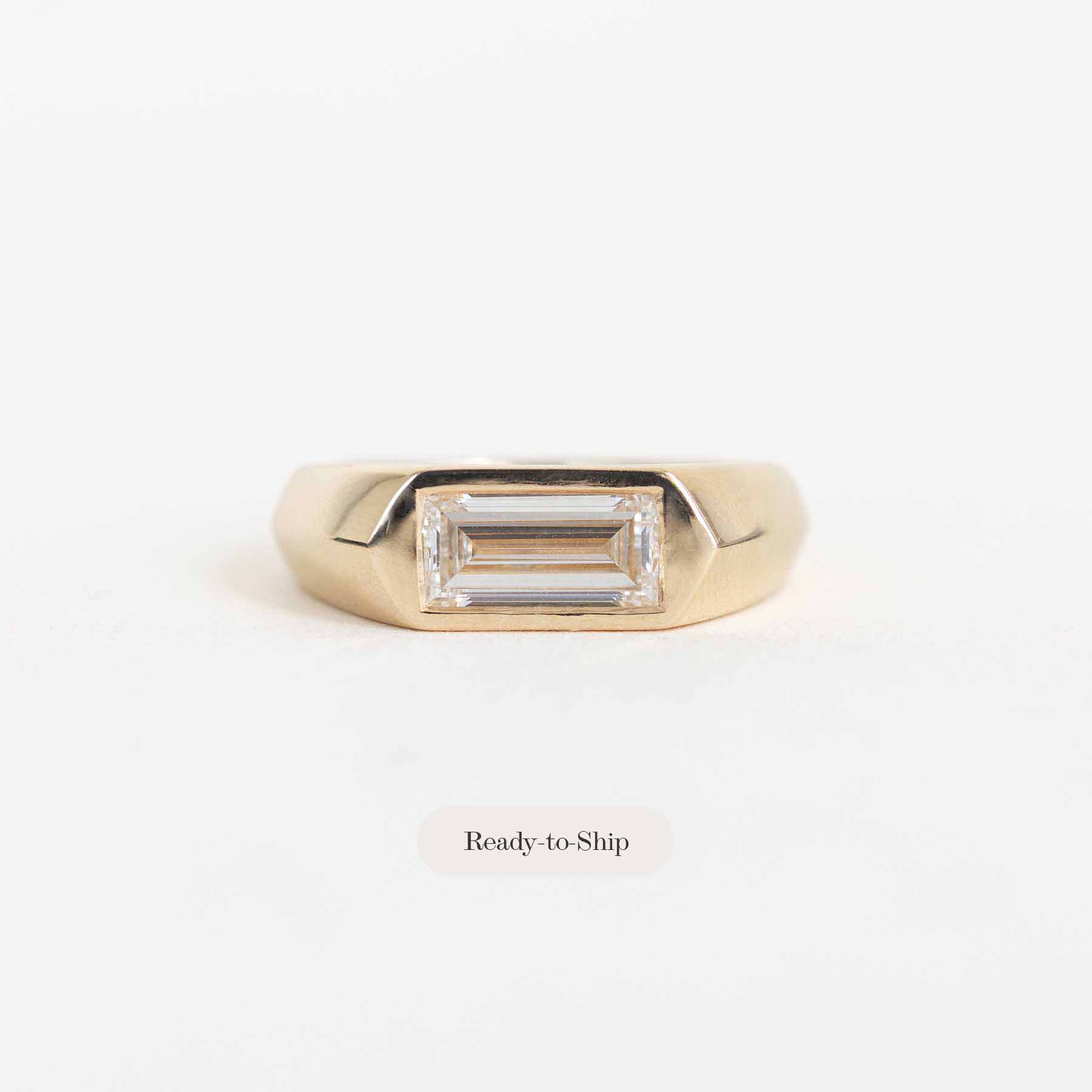 A gold ring with a rectangular baguette-cut clear gemstone, shown on a plain white background with a 'Ready-to-Ship' label below.