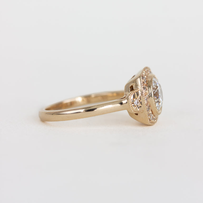 Gold ring with a diamond on a light gray background