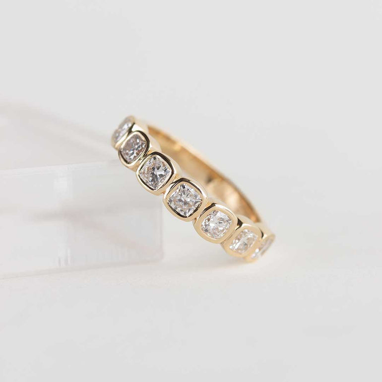Yellow gold ring with 7 bezel-set, cushion cut laboratory grown diamonds