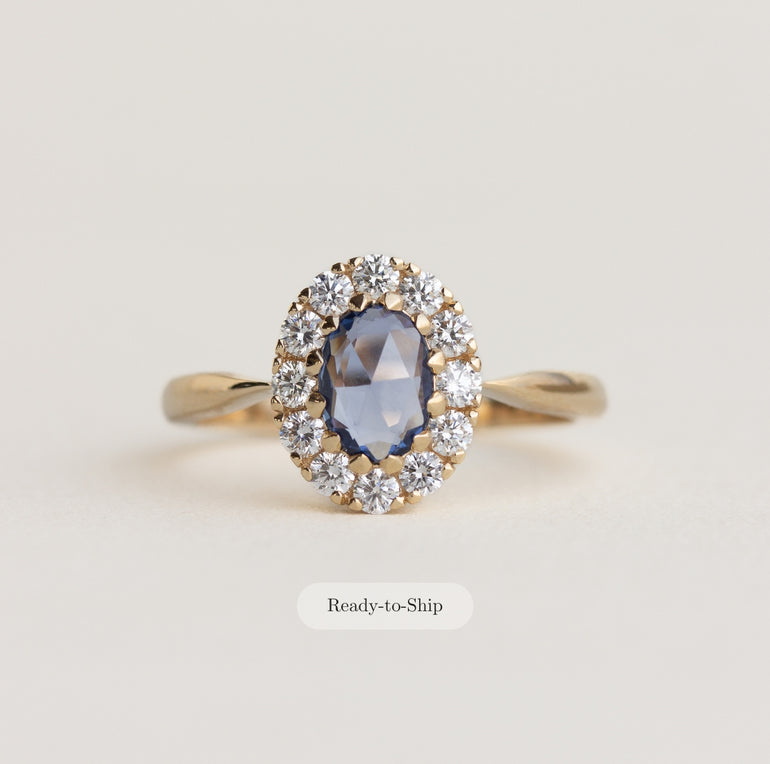 14K gold ring with a blue sapphire and diamond halo