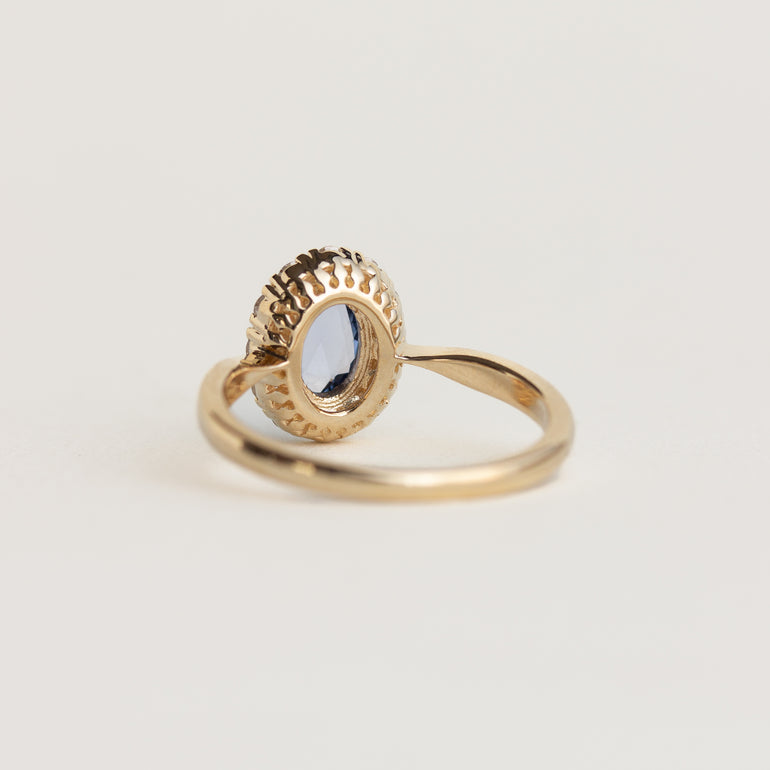 14K gold ring with a blue sapphire and diamond halo