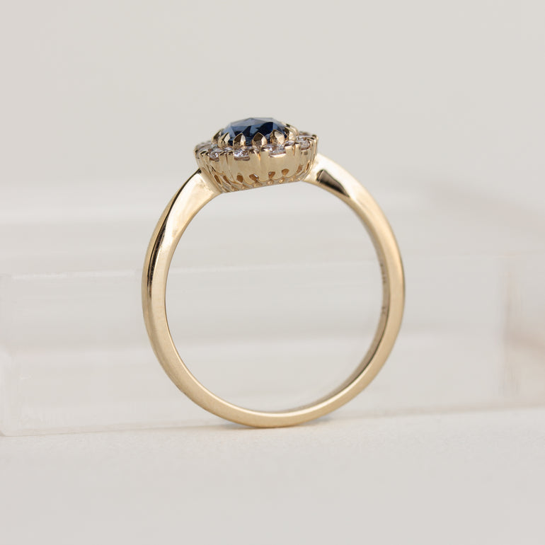 14K gold ring with a blue sapphire and diamond halo