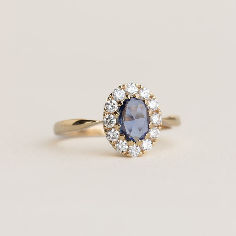 14K gold ring with a blue sapphire and diamond halo