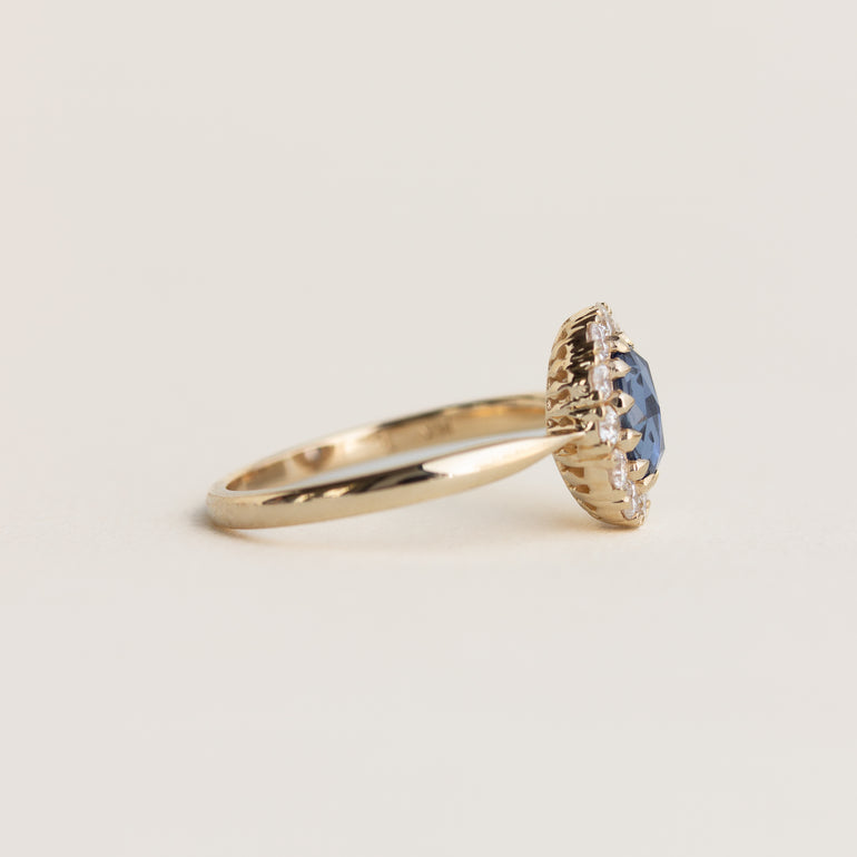 14K gold ring with a blue sapphire and diamond halo