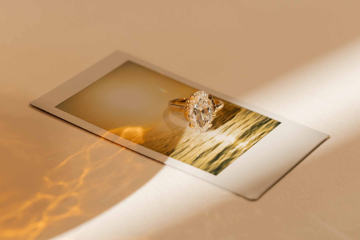 A vintage ring with lab diamond sitting on a polaroid photo