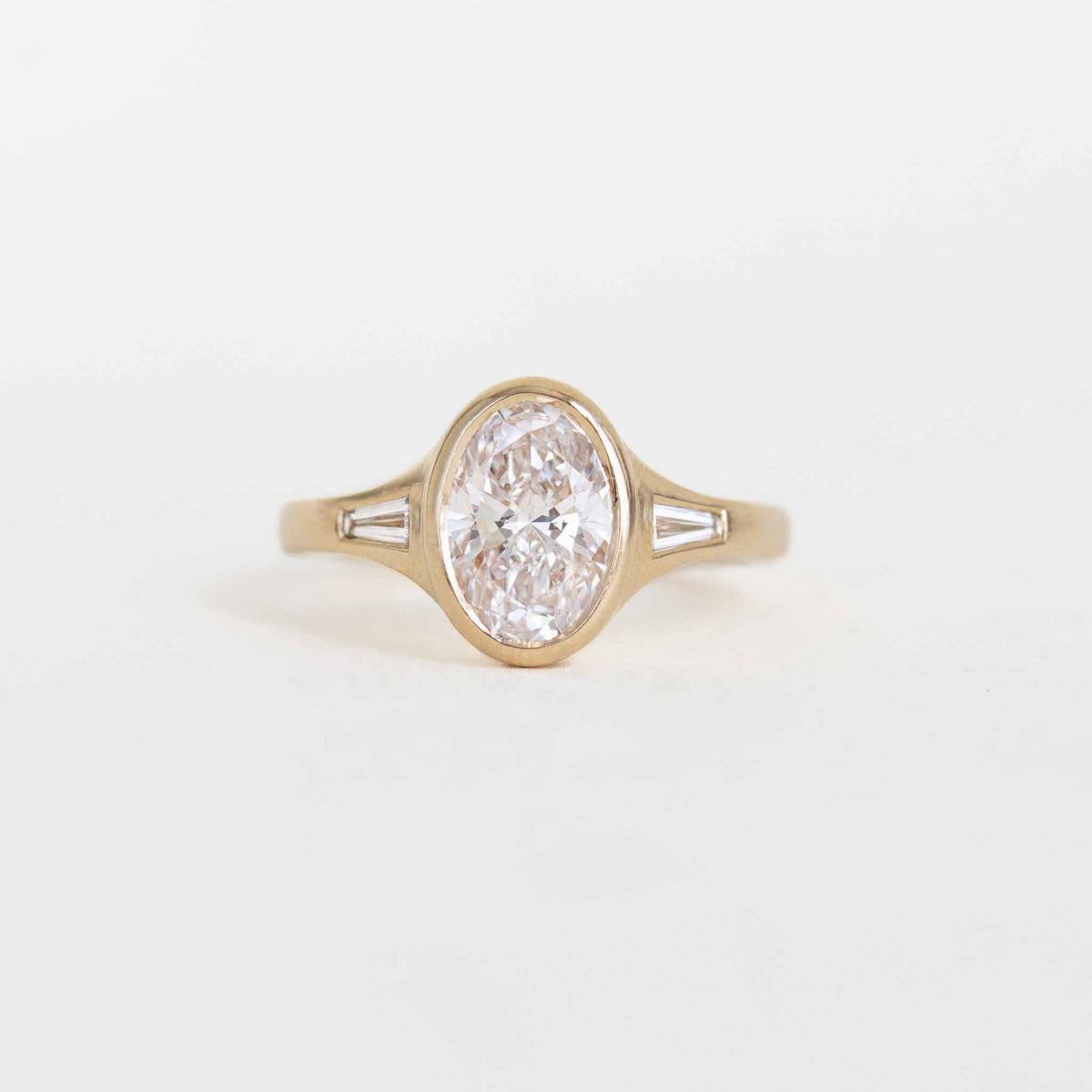 Oval Bezel Set Diamond Ring with Baguette Side Stones