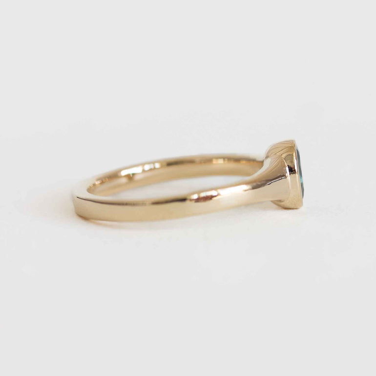 Gold ring with a diamond on a white background