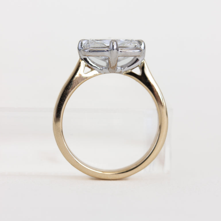 Gold ring with a diamond on a white background