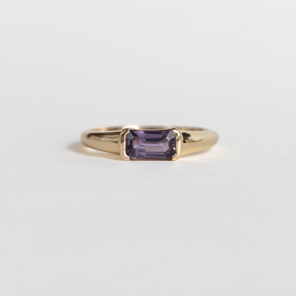 East west, half bezel set purple sapphire engagement ring