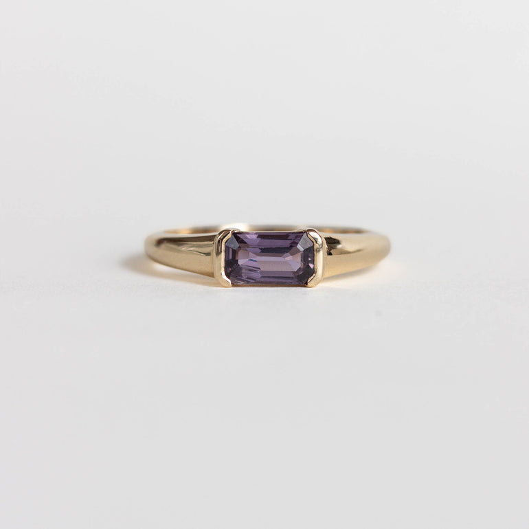 East west, half bezel set purple sapphire engagement ring