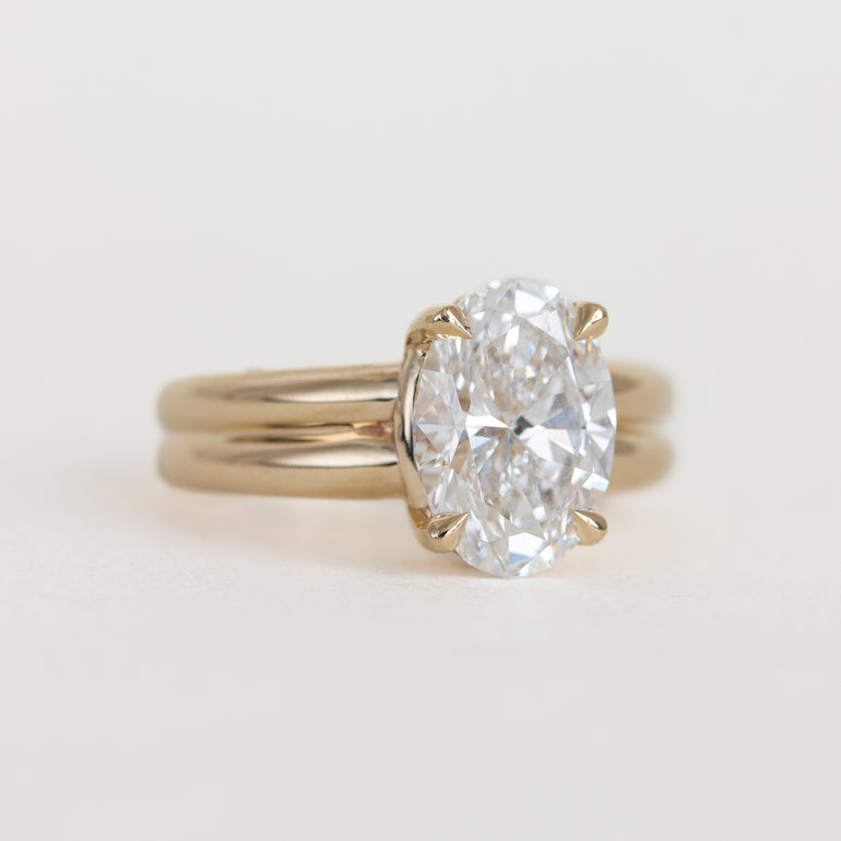 Gold ring with a large diamond on a light background