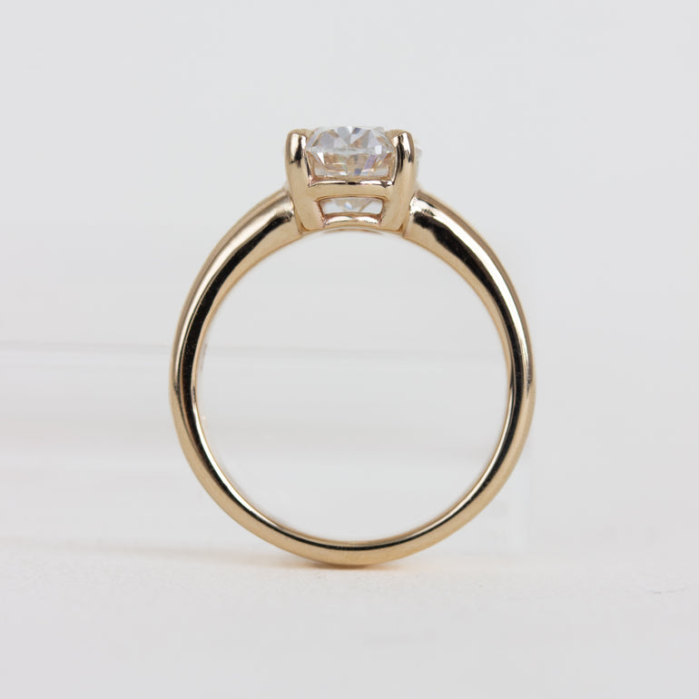 Gold ring with a diamond on a white background