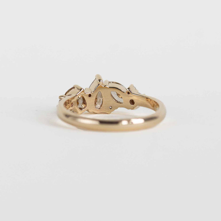 A gold ring cluster ring with champagne and clear natural diamonds, shown on a plain white background.
