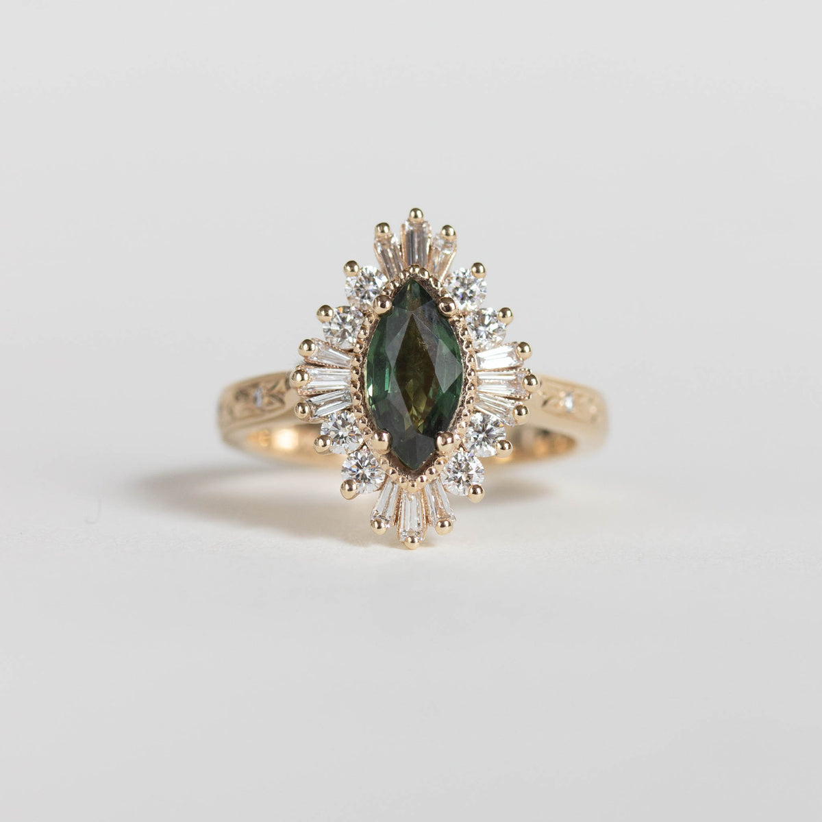 Ornate engraved halo diamond engagement ring with green sapphire