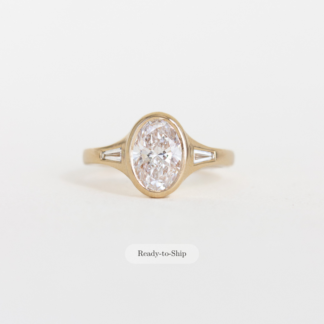 Oval Bezel Set Diamond Ring with Baguette Side Stones