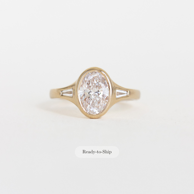 Oval Bezel Set Diamond Ring with Baguette Side Stones