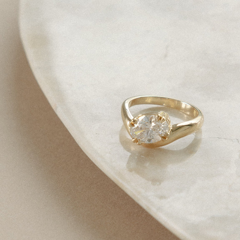 Oval Diamond engagement ring with curved 14k yellow band