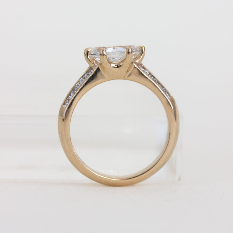 Rose gold ring with a diamond on a white background