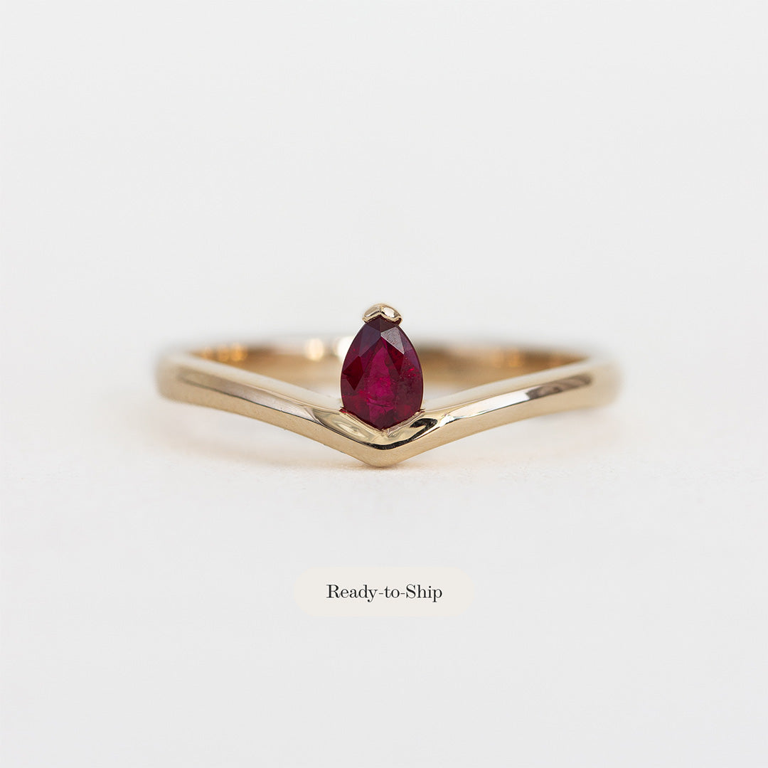 Face on photos of 14K yellow gold ring with pear shaped ruby