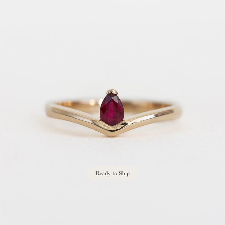 Face on photos of 14K yellow gold ring with pear shaped ruby