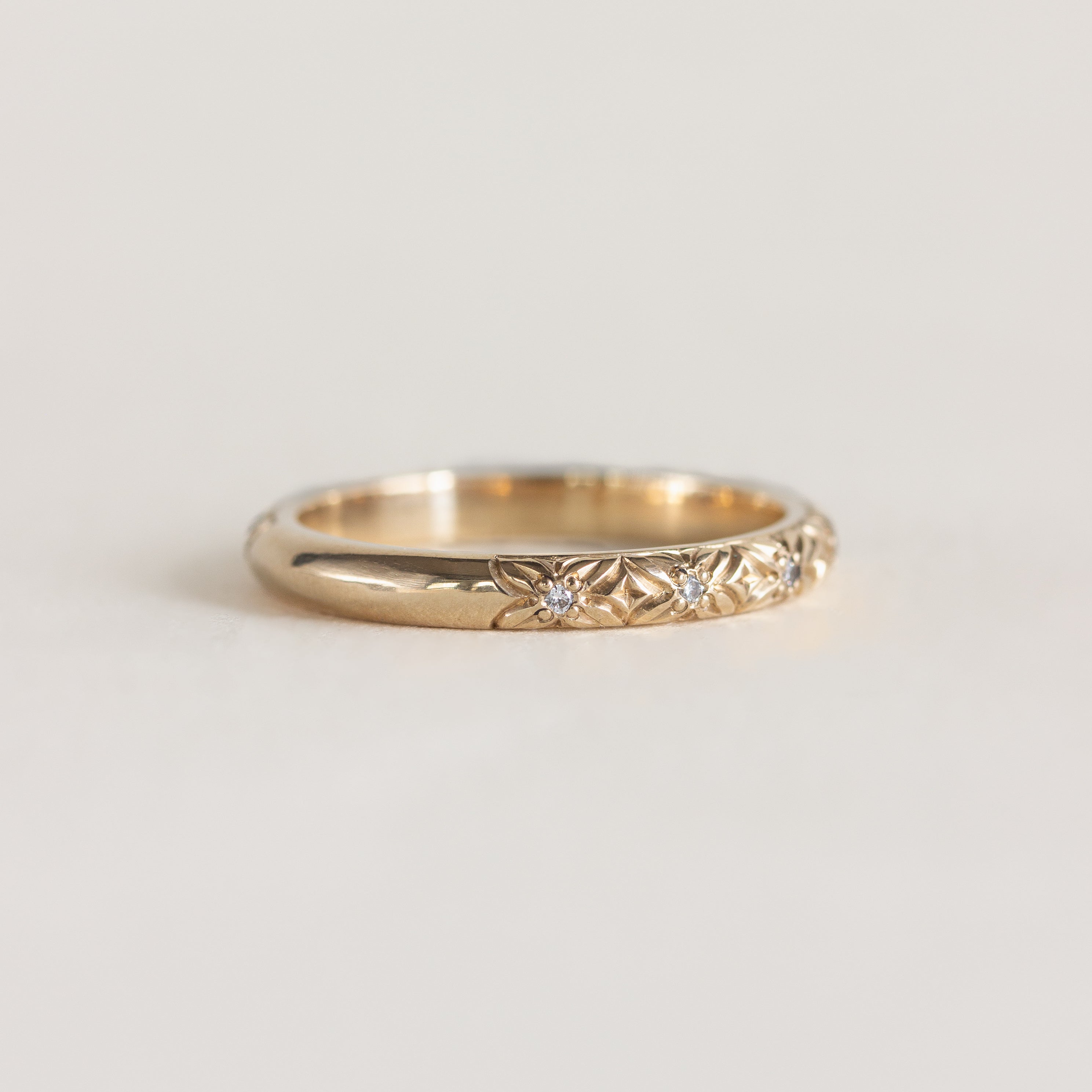 14K gold band, engraved floral design with diamond centres