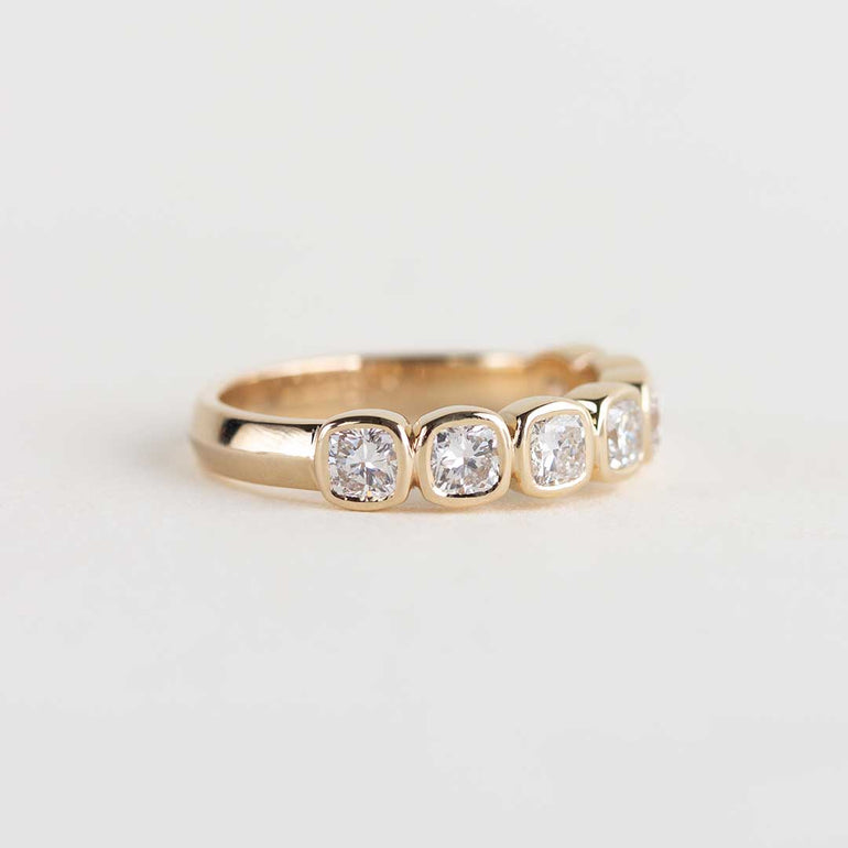 Yellow gold ring with 7 bezel-set, cushion cut laboratory grown diamonds