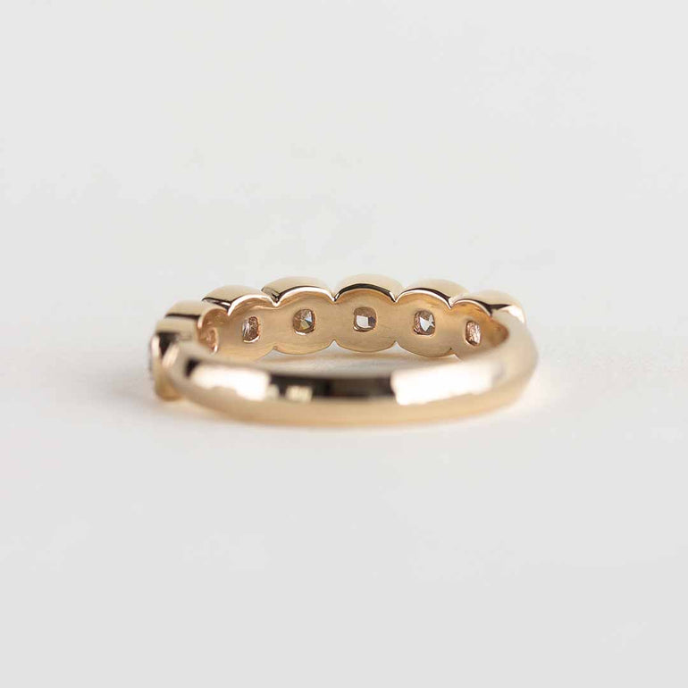 Yellow gold ring with 7 bezel-set, cushion cut laboratory grown diamonds