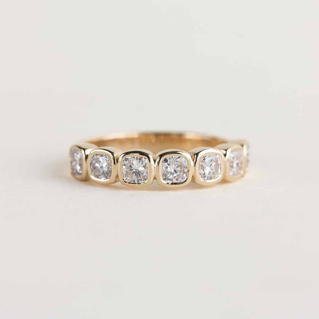 Yellow gold ring with 7 bezel-set, cushion cut laboratory grown diamonds