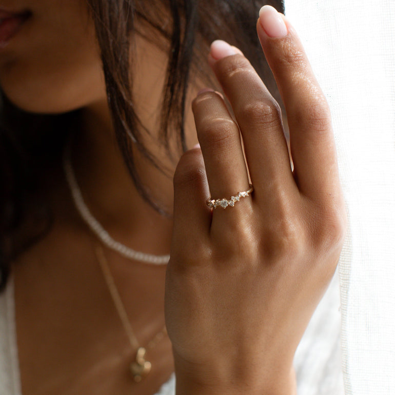 diamond cluster wedding band on models hand