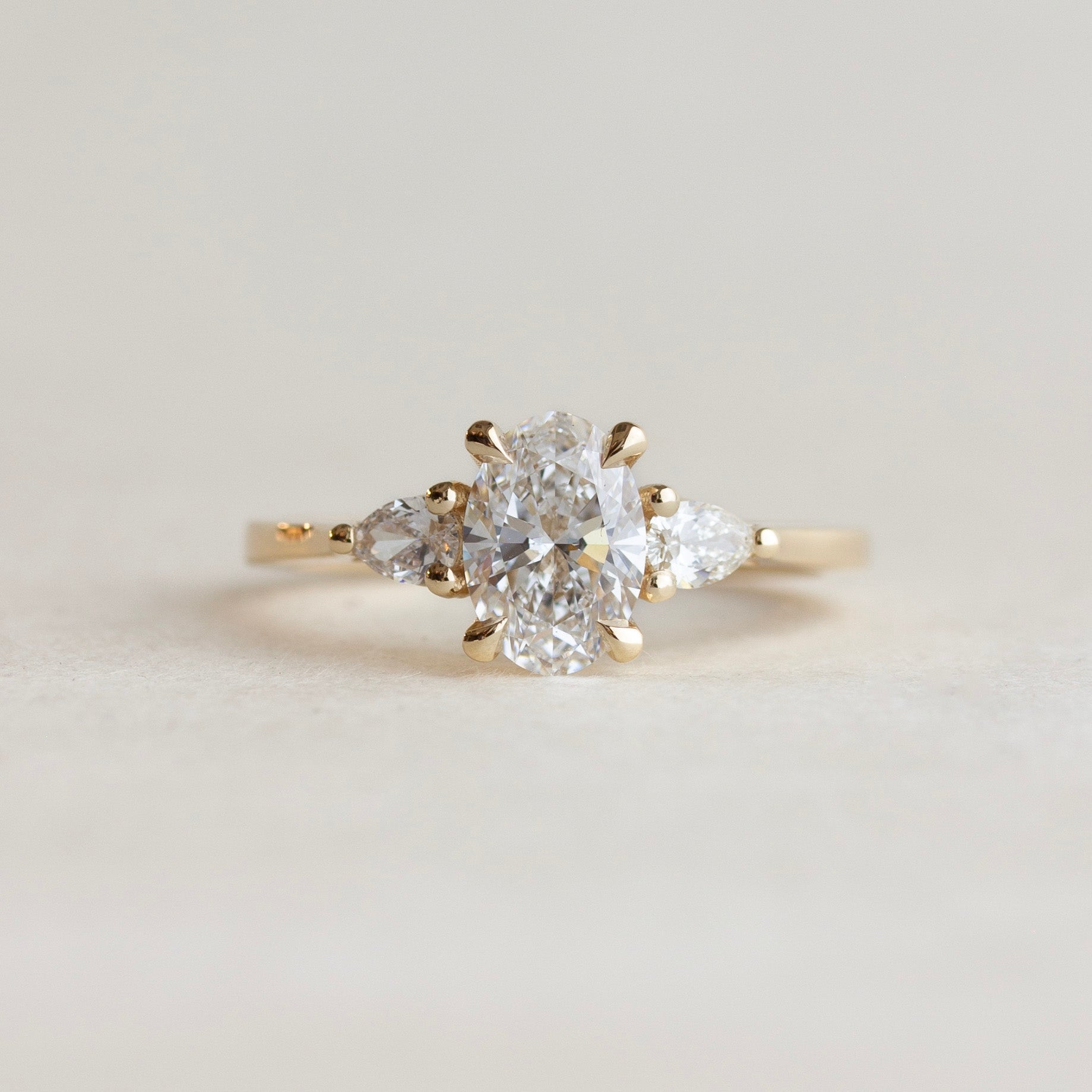 Oval Diamond Engagement Ring With Pear Side Stones