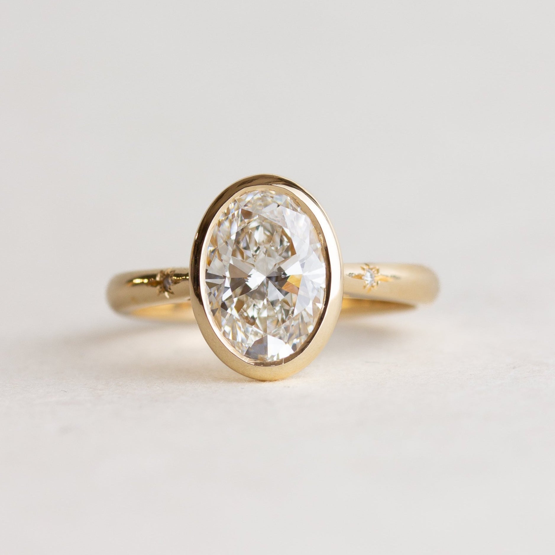Bezel Set Oval Star Set Side Stone Engagement Ring