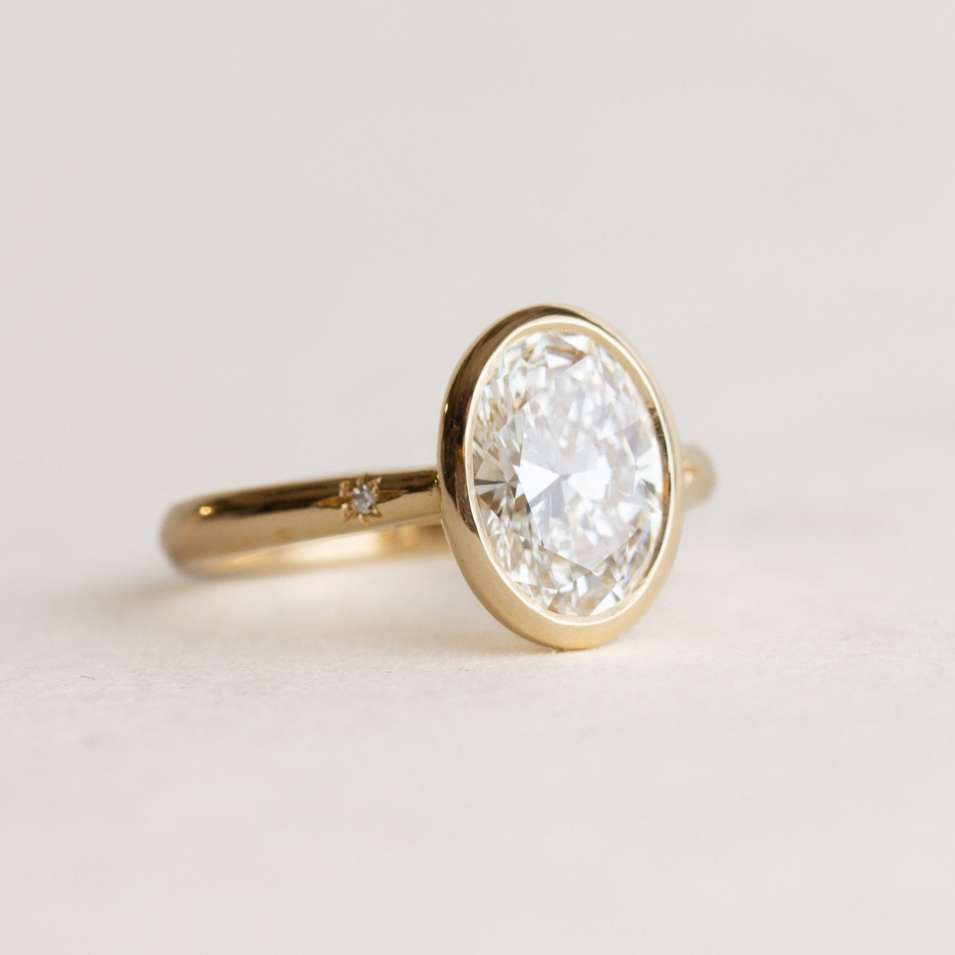 Oval Bezel Star Set Side Stones Engagement Ring