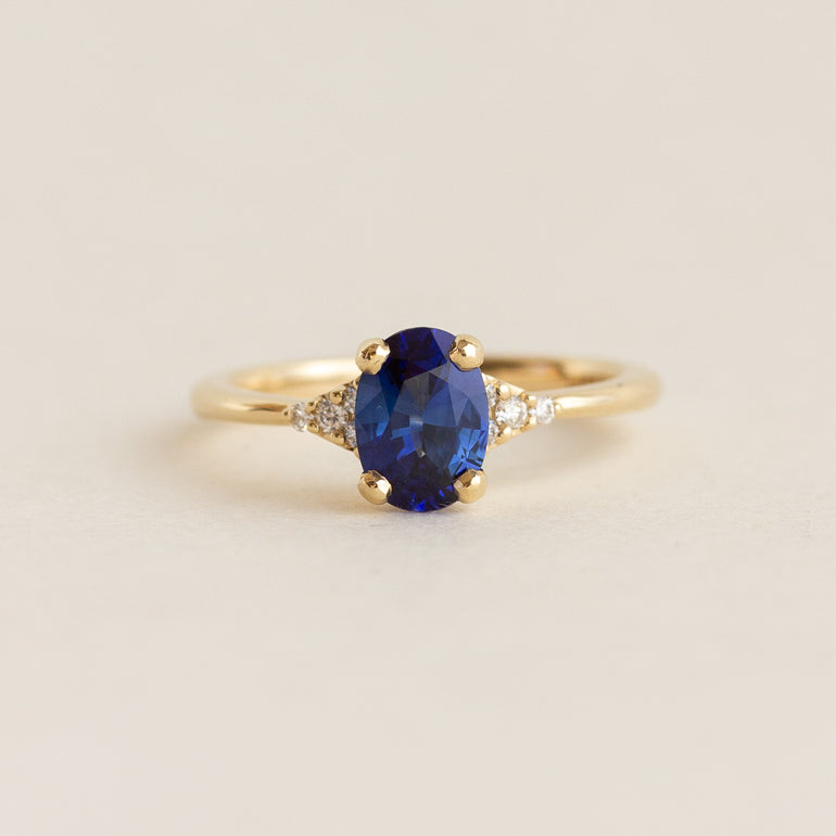 Blue Oval Sapphire Side Stone Engagement Ring