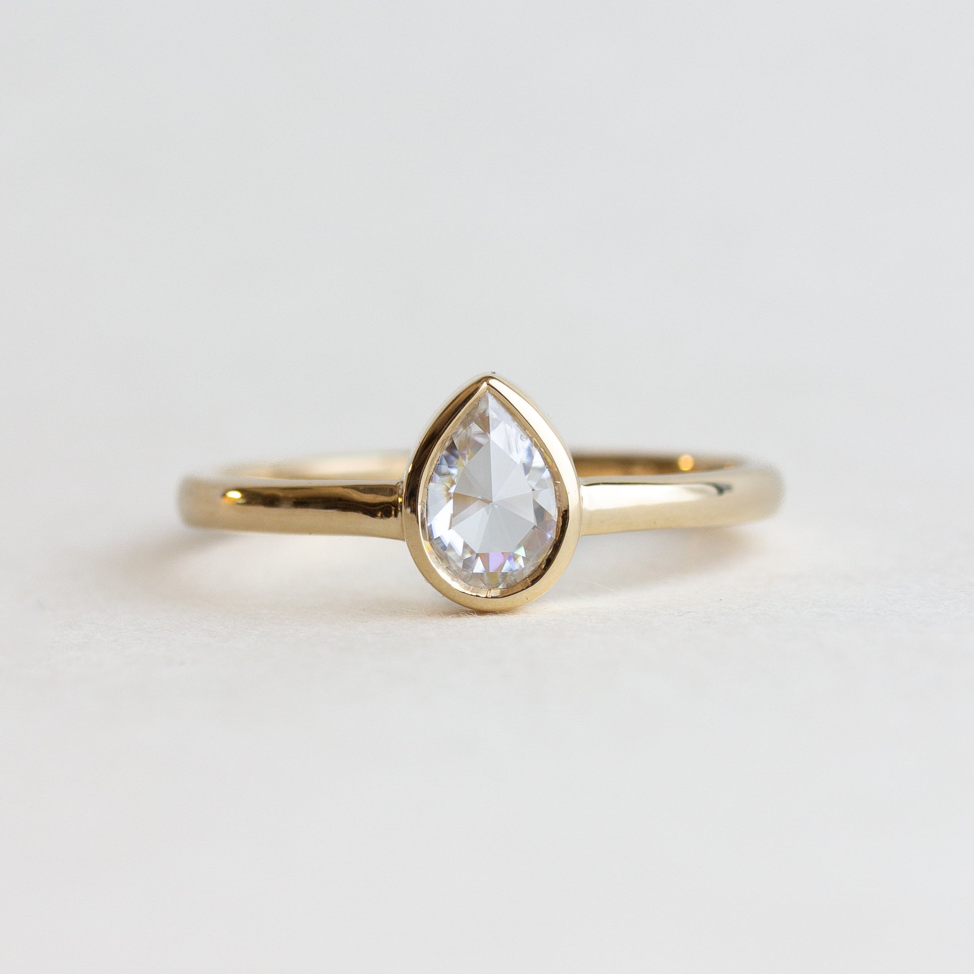 White Stone Pear Bezel Engagement Ring