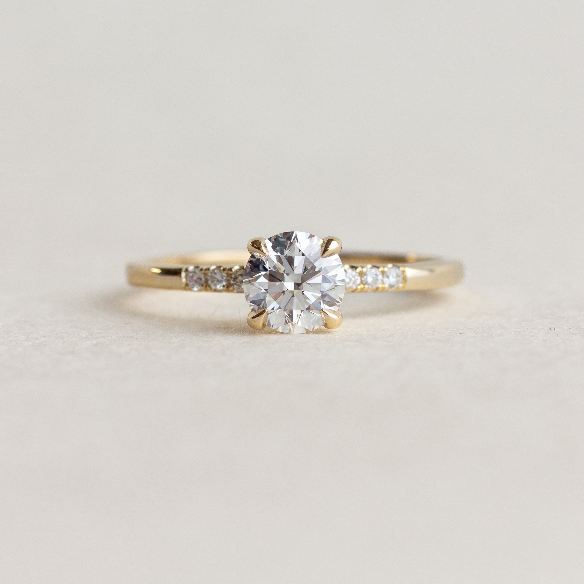 White Stone Side Stone Engagement Ring