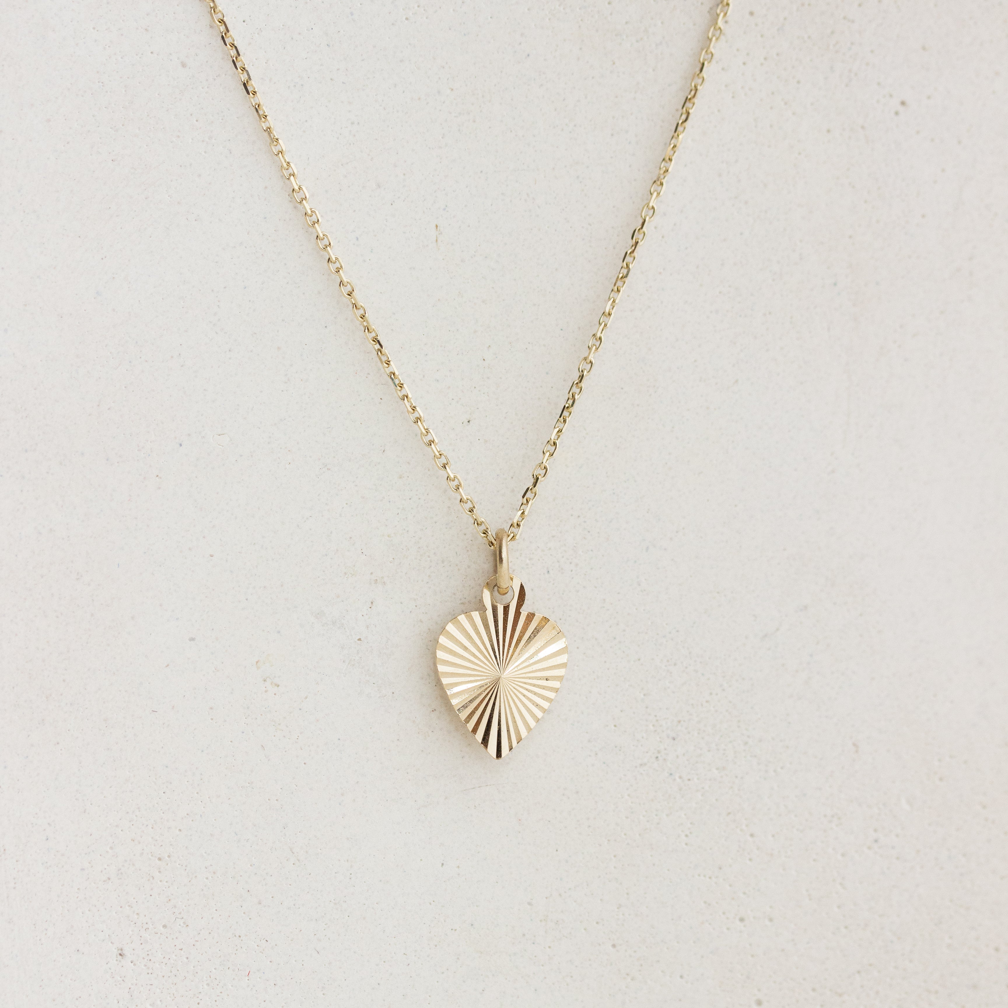 sunburst engraved heart charm