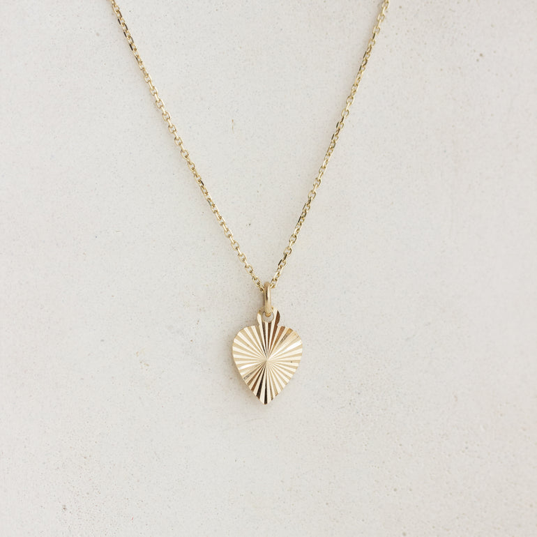 sunburst engraved heart charm