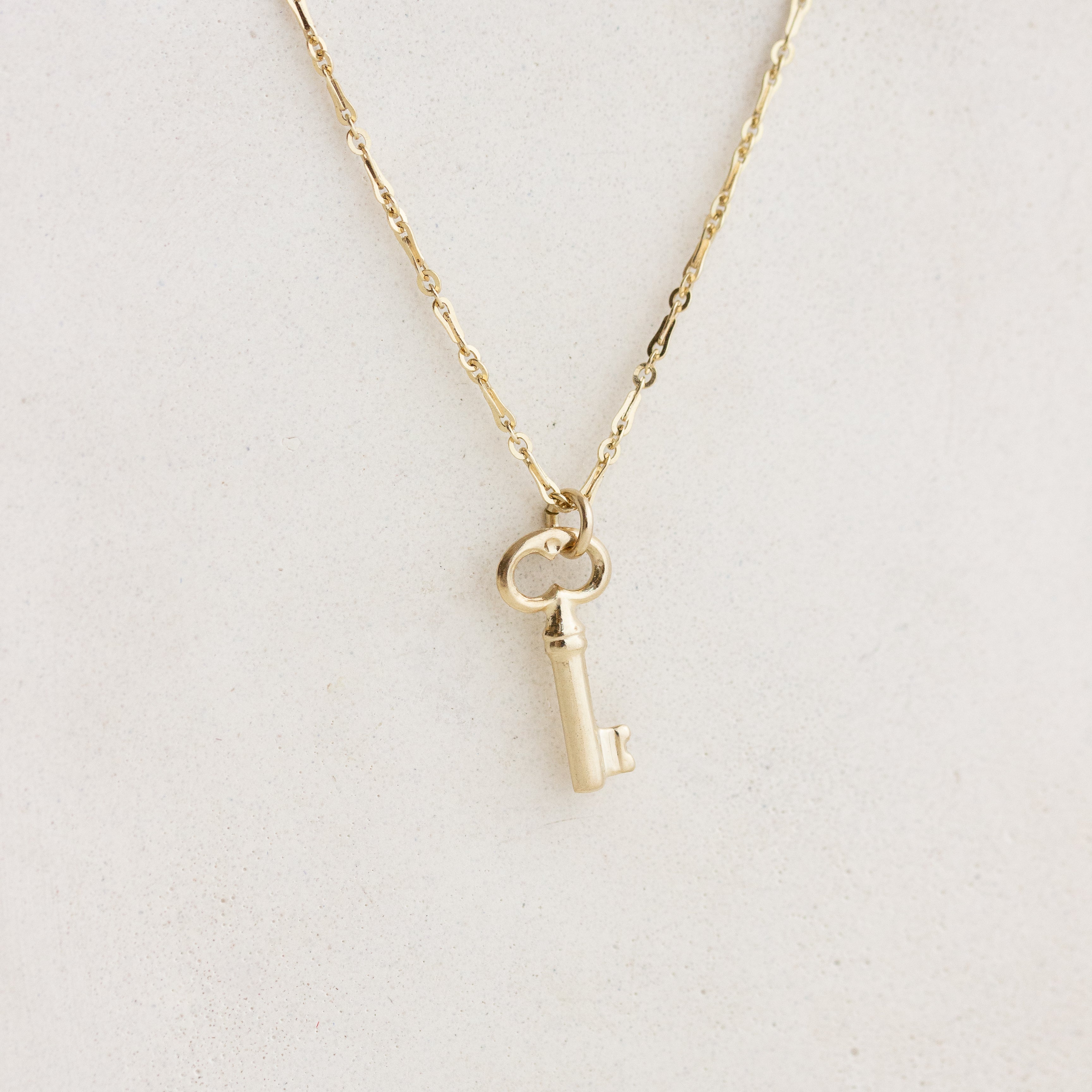 gold key charm on chain