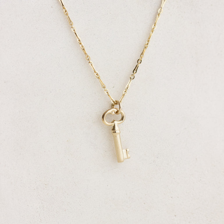 gold key charm on chain